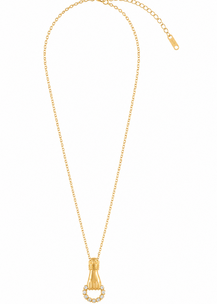 A gold necklace featuring a champagne bottle pendant with a halo of small clear stones, displayed on a clean white background.