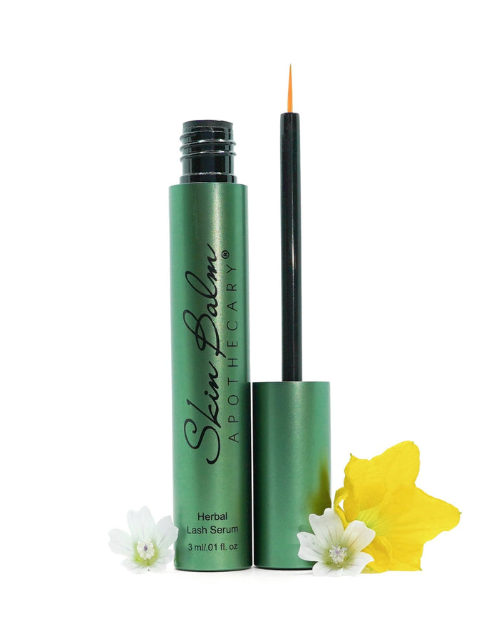 Open Herbal Lash Serum tube with applicator and floral elements against a white background.